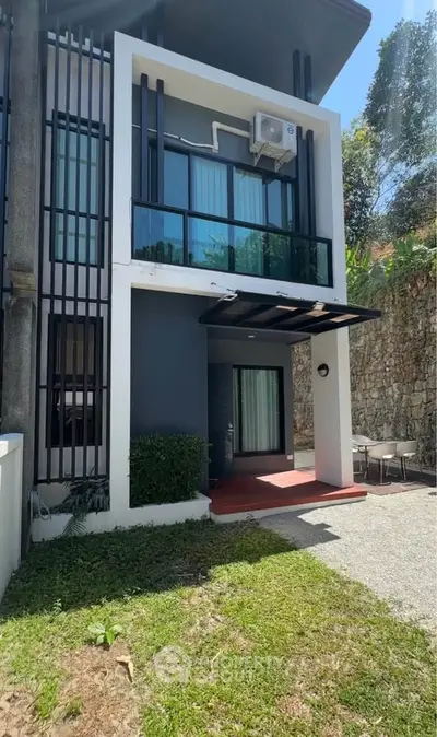 Modern two-story house with sleek design and lush greenery, perfect for contemporary living.