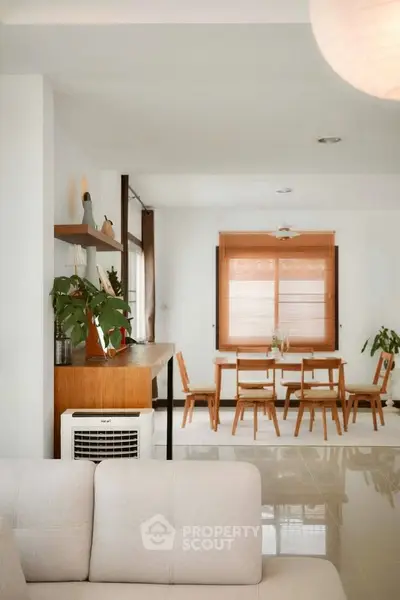 Modern open-plan living and dining area with stylish decor and natural light.