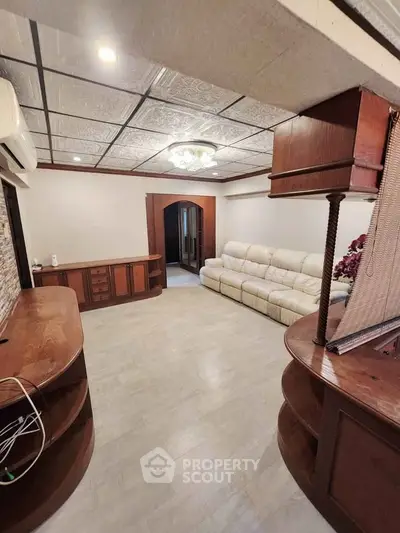 Spacious living room with elegant ceiling design and cozy seating area.