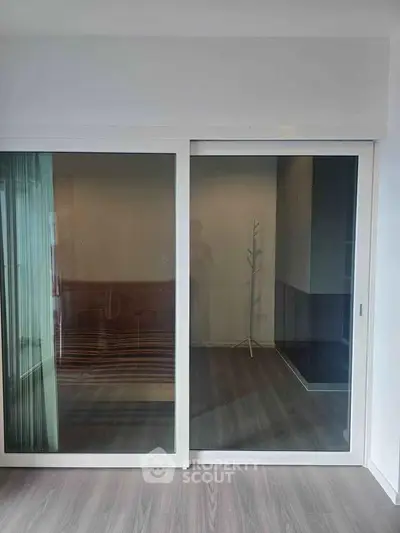 Modern interior with sliding glass doors and sleek flooring, perfect for contemporary living spaces.