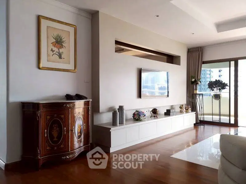 Elegant living room with modern decor and spacious balcony view.