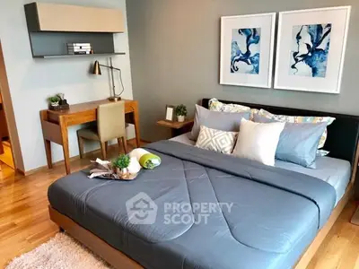 Modern bedroom with stylish decor and cozy ambiance, featuring a comfortable bed and a functional study area.