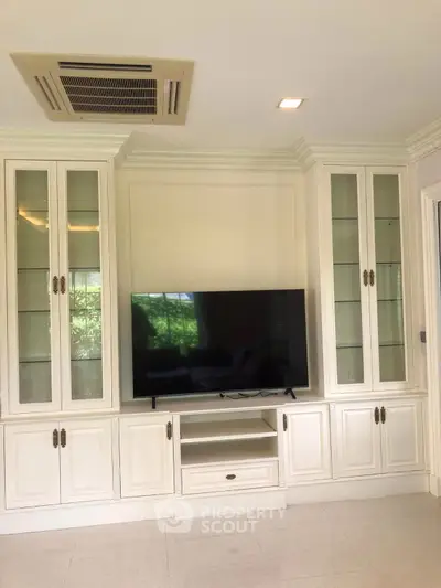 Elegant living room with built-in cabinets and modern TV setup