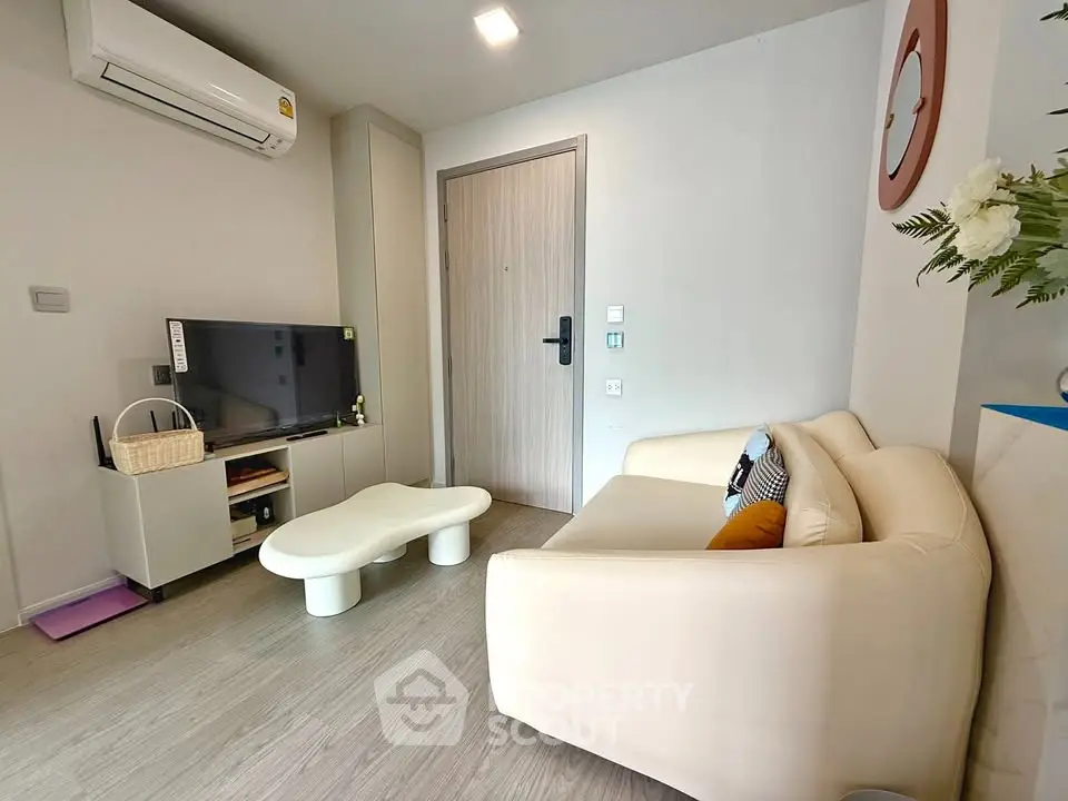 Modern living room with sleek furniture and air conditioning, perfect for cozy relaxation.