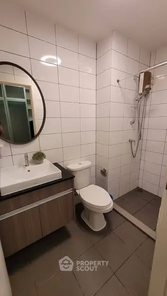 Modern bathroom with sleek fixtures and tiled walls in a contemporary apartment.