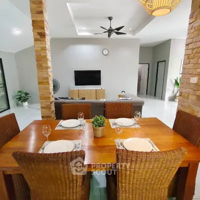 Spacious open-plan living and dining area with modern decor and natural light.