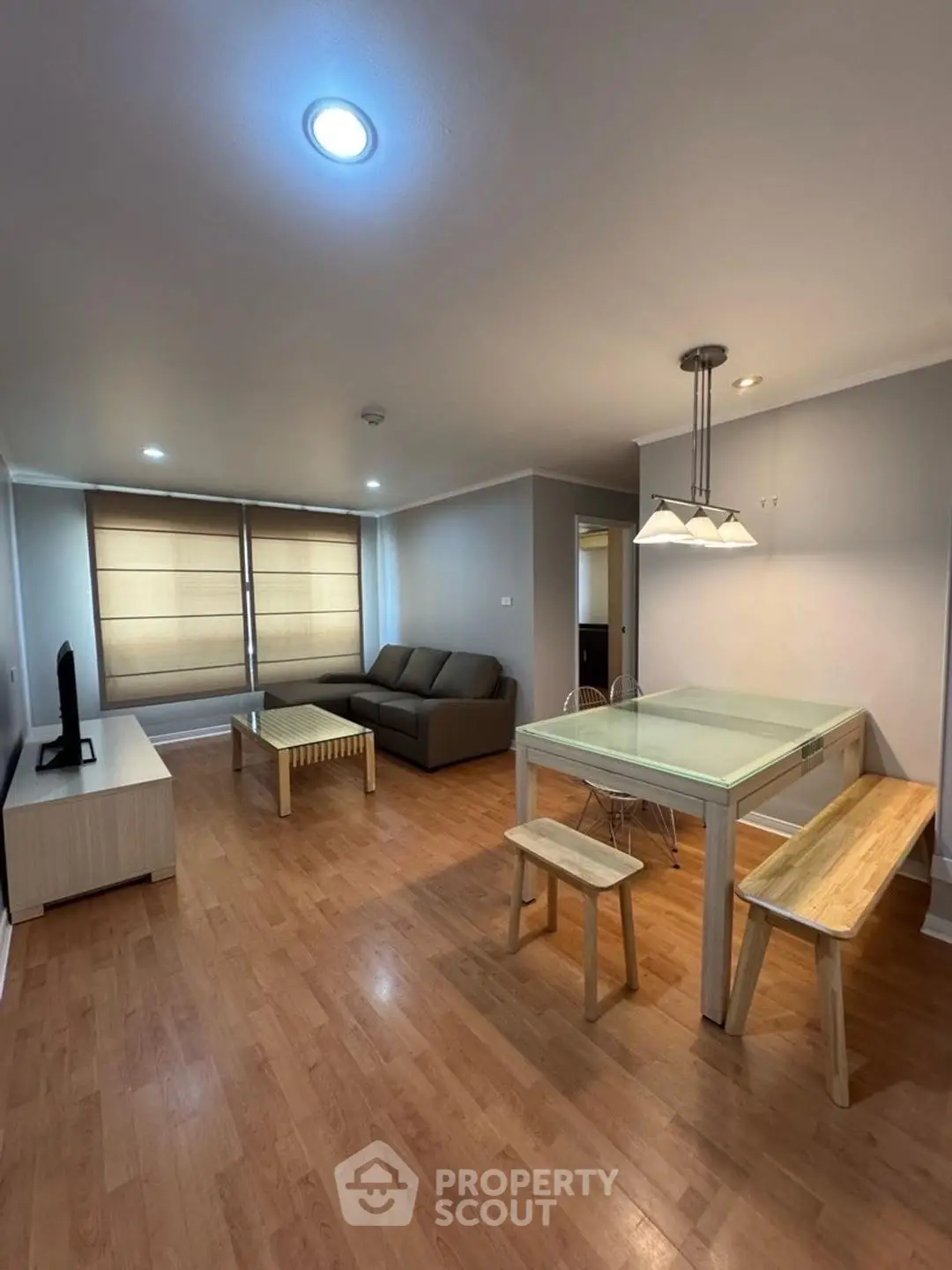 Spacious living room with modern furniture and wooden flooring