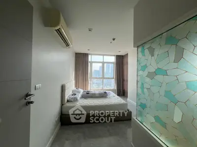 Modern bedroom with large window offering stunning city view and stylish decor