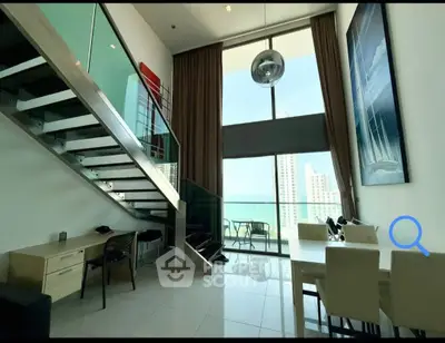 Stunning duplex with floor-to-ceiling windows and modern staircase, offering breathtaking city views.