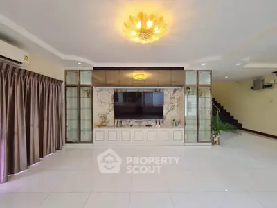 Spacious living room with elegant chandelier and modern decor