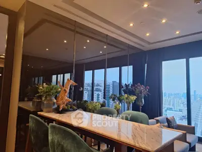 Luxurious dining area with city view, elegant decor, and marble table in modern apartment.