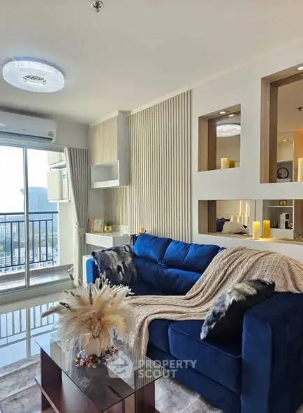 Stylish living room with blue sofa and city view balcony, modern decor