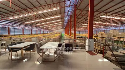 Spacious industrial warehouse with mezzanine office space and modern design.