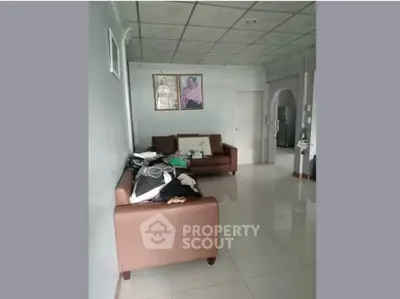 Spacious living room with elegant ceiling design and comfortable seating area.