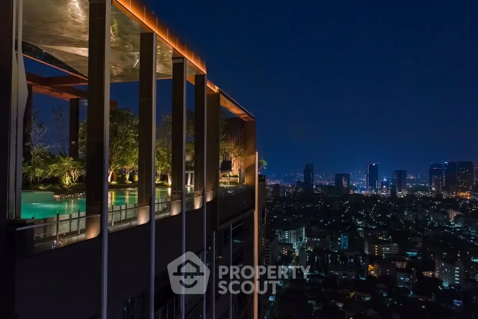Luxurious rooftop pool with stunning city skyline view at night, perfect for urban living enthusiasts.