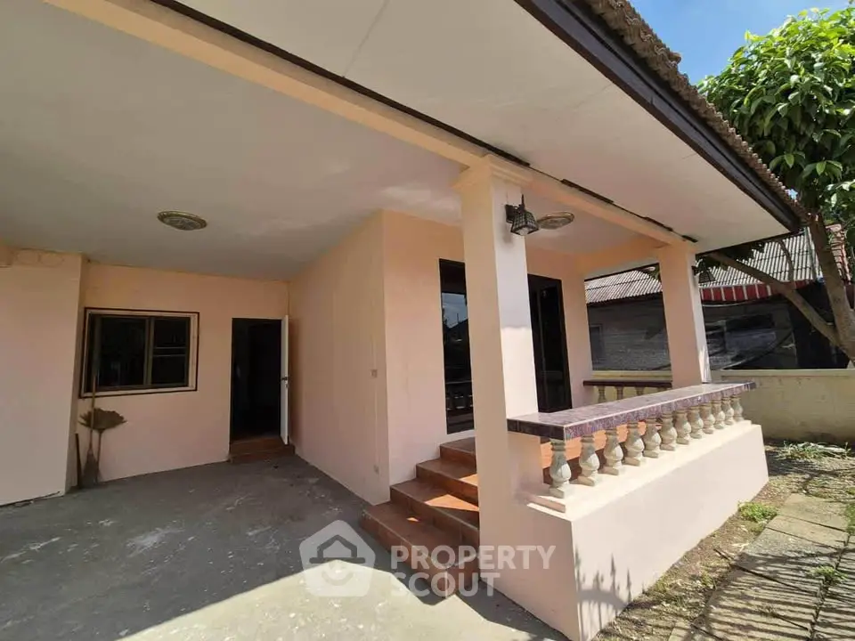 Charming single-story home with covered porch and inviting entrance, perfect for cozy living.