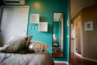 Stylish bedroom with teal accent wall and modern decor