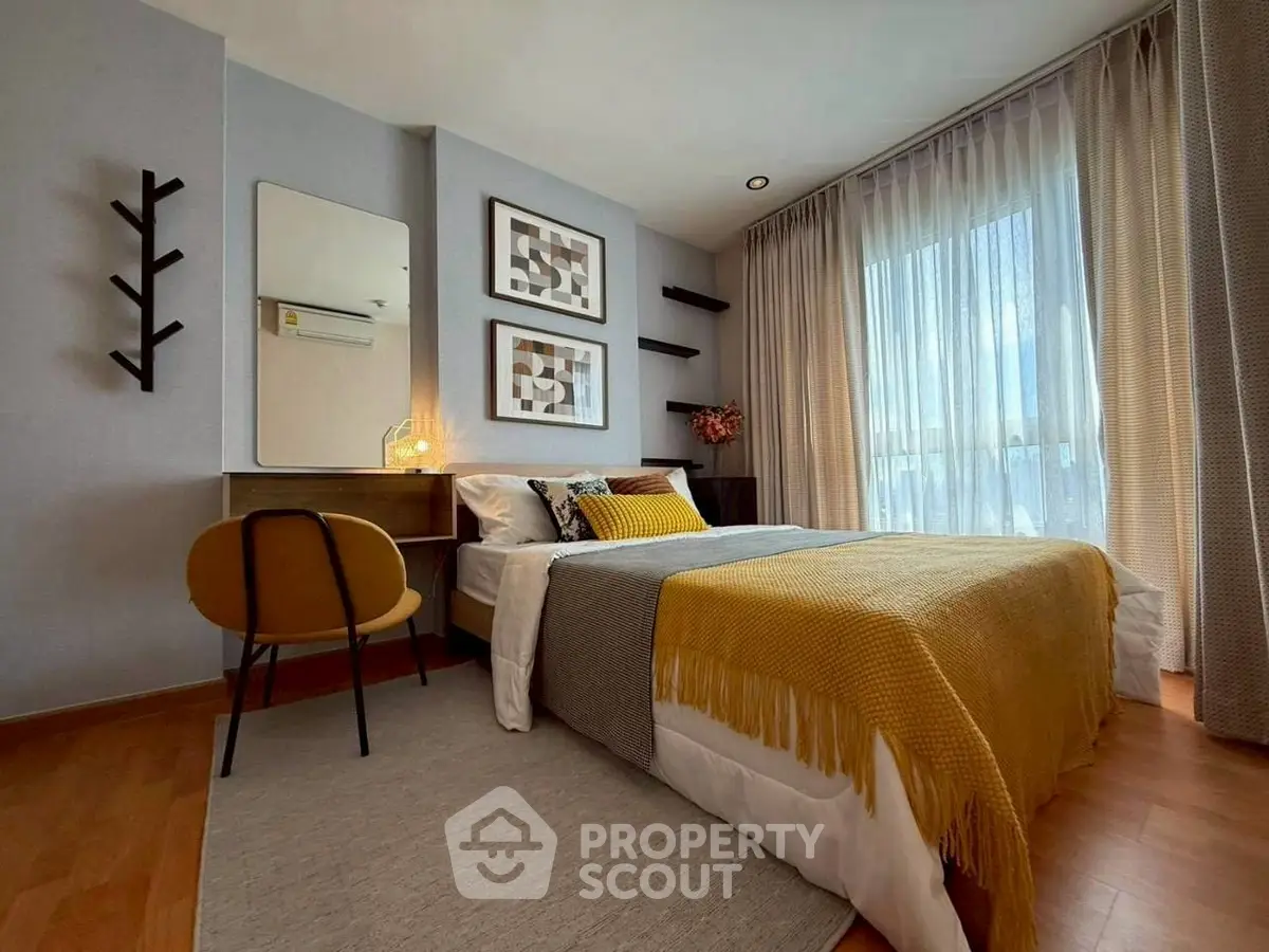 Modern bedroom with stylish decor and large window for natural light