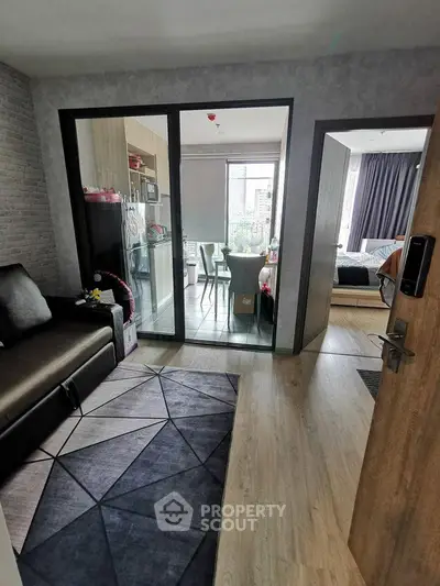 Modern apartment interior with open layout, featuring a cozy living area and stylish bedroom.