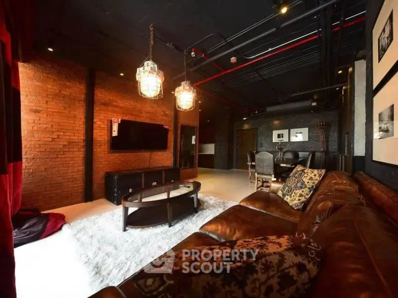 Luxurious industrial-style living room with leather sofa and exposed brick walls.