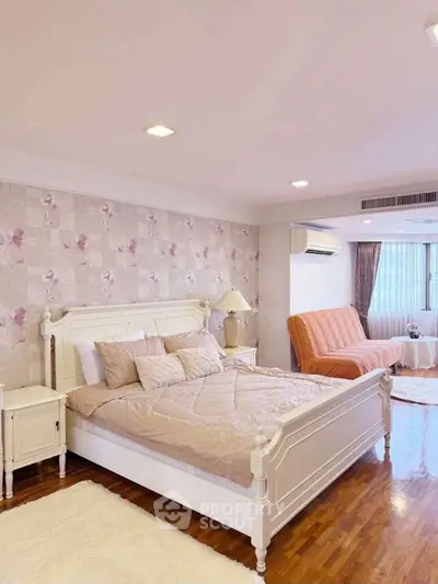 Spacious bedroom with elegant decor and natural light, featuring a cozy bed and stylish furnishings.