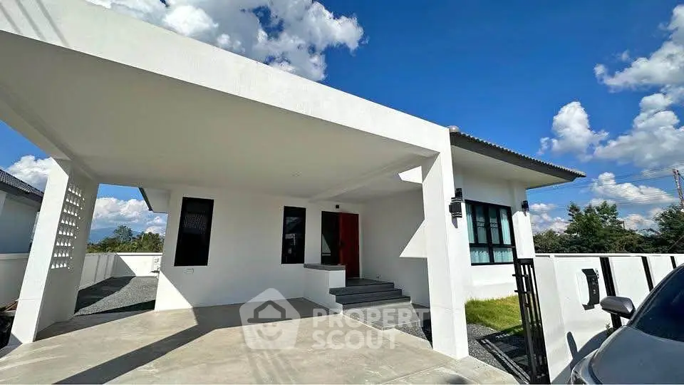 Modern single-story white house with carport and clear blue sky