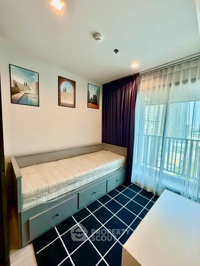 Modern bedroom with daybed and city view, featuring stylish decor and ample natural light.