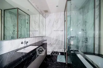 Luxurious modern bathroom with marble walls and sleek black countertops