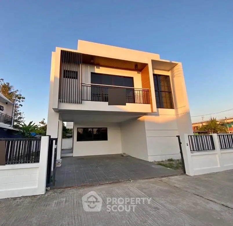 Modern two-story house with sleek design and spacious driveway in a serene neighborhood.