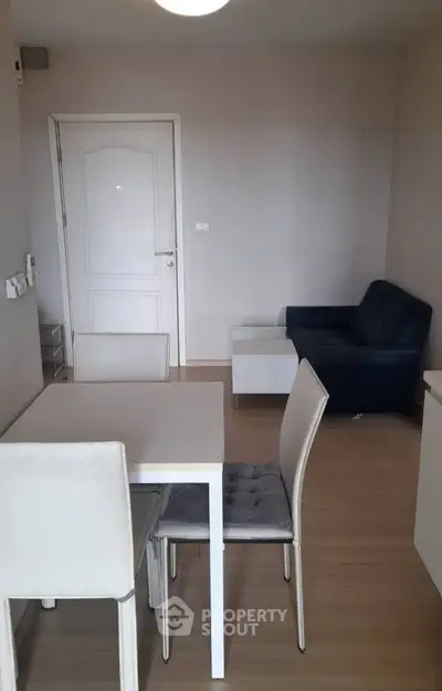 Cozy living room with modern furniture and wooden flooring in a stylish apartment.