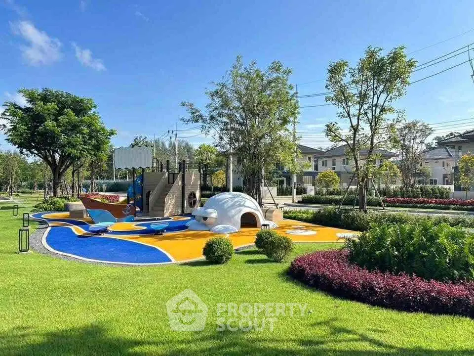 Beautiful residential garden with modern playground and lush greenery.