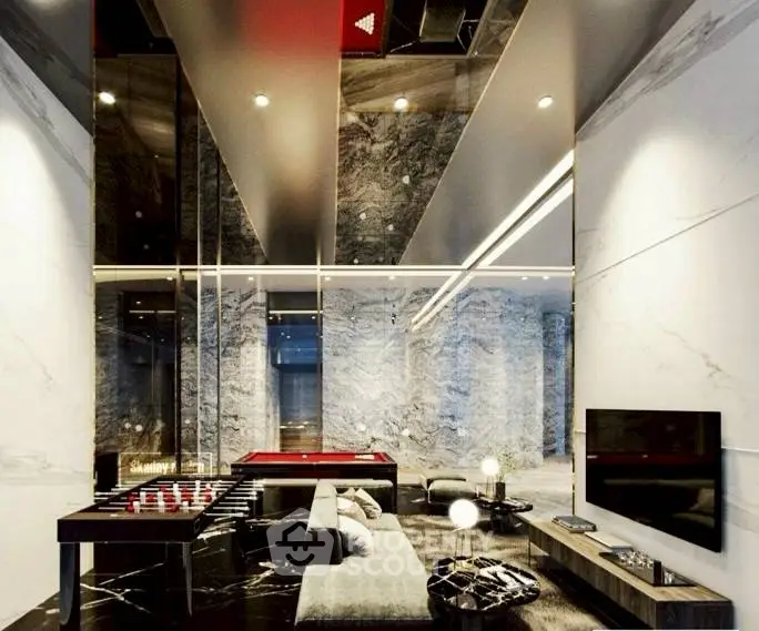 Luxurious modern living room with marble walls and sleek furniture, featuring a foosball table and large TV.