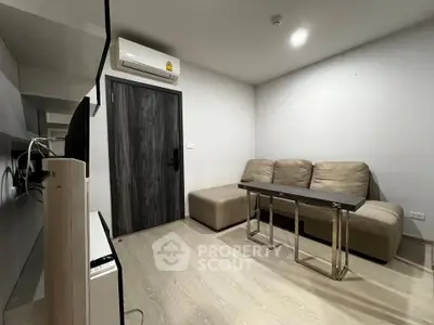 Modern living room with sleek design and air conditioning, featuring a comfortable sofa and stylish table.