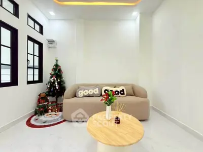 Cozy living room with festive decor and modern furnishings, perfect for holiday gatherings.