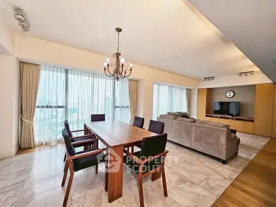 Spacious open-plan living and dining area with modern furnishings and large windows.