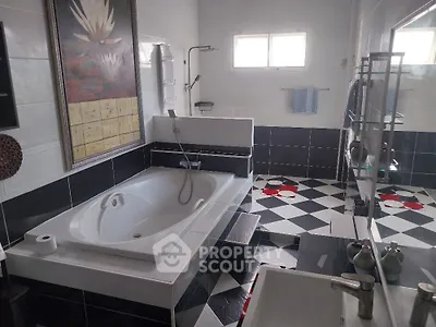 Luxurious bathroom with modern black and white tiles and large bathtub
