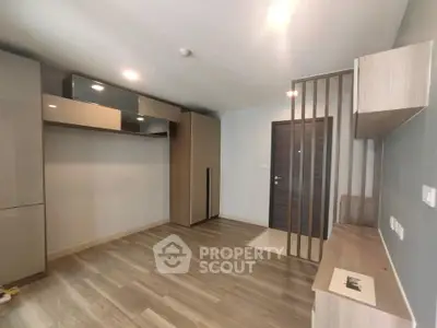 Modern interior with wooden flooring and sleek storage solutions in a compact living space.