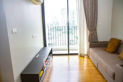 Modern living room with balcony view in high-rise apartment