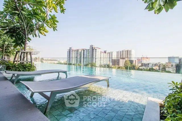 Luxurious rooftop pool with stunning city view and modern lounge chairs.