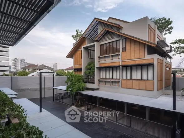 Modern multi-story building with wooden accents and spacious courtyard