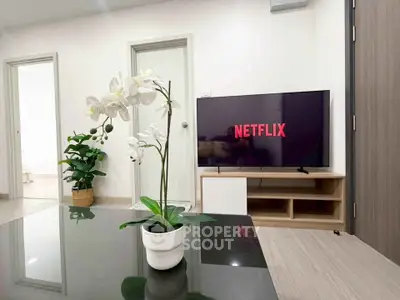 Modern living room with sleek TV setup and elegant decor, perfect for relaxation and entertainment.
