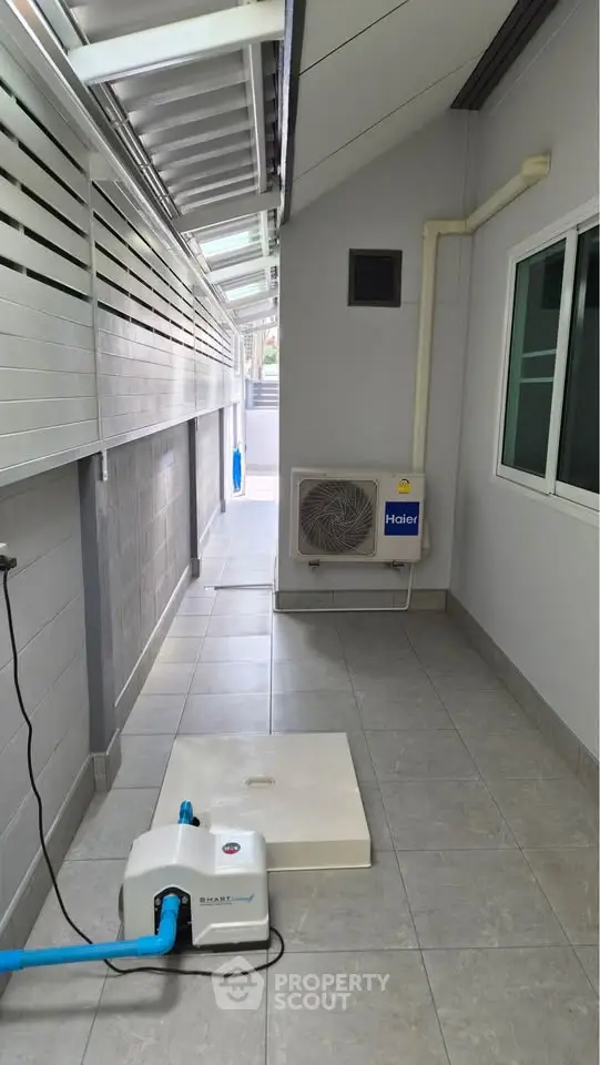 Modern exterior corridor with air conditioning unit and sleek design