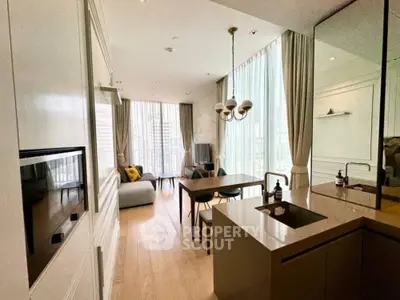 Modern open-layout living room with kitchen, featuring floor-to-ceiling windows and elegant decor.