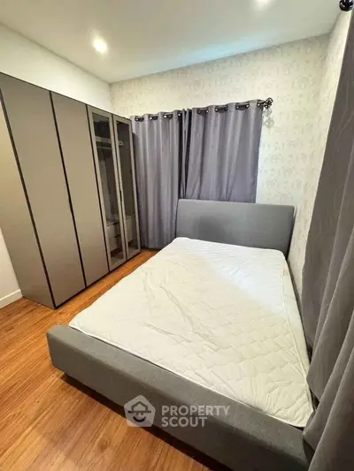 Modern bedroom with sleek wardrobe and cozy bed in stylish apartment