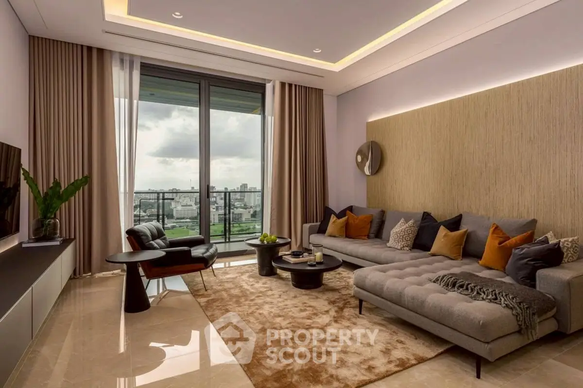 Luxurious living room with modern decor and stunning city view from large windows.