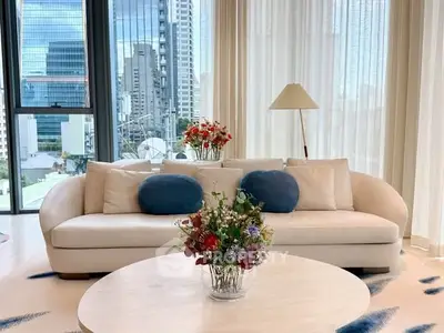 Luxurious living room with modern sofa and city view, perfect for urban living.