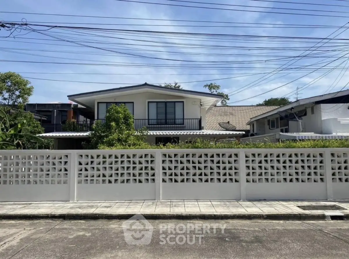 Charming suburban house with modern design and spacious front yard, perfect for family living.