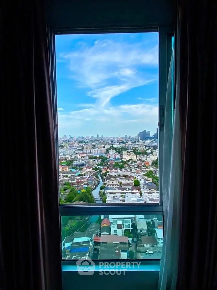 Stunning cityscape view from a high-rise apartment window, showcasing vibrant urban skyline.