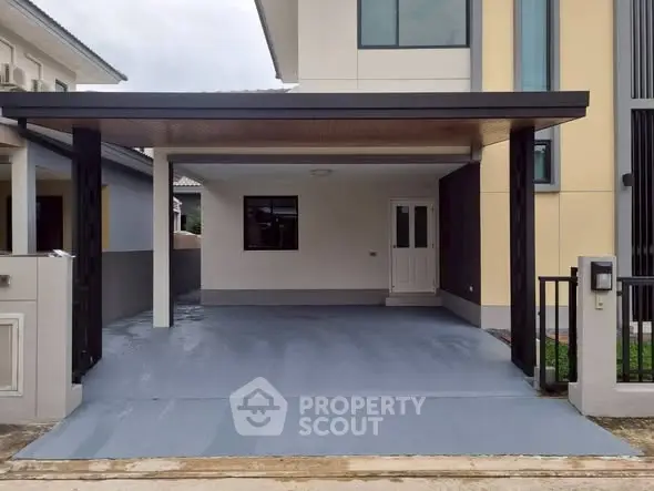 Modern house with covered parking area and sleek exterior design.