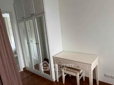 Elegant bedroom with mirrored wardrobe and stylish dressing table